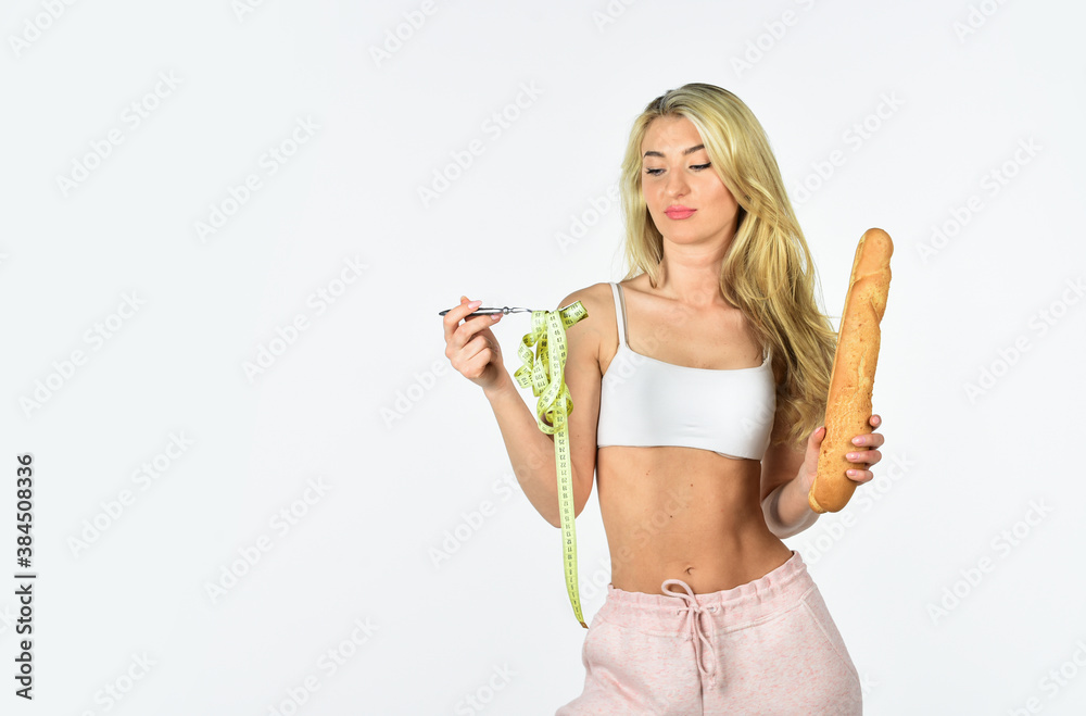 sport and fitness. healthy eating lifestyle. athletic woman isolated on white. girl in sportswear with tape measure on fork. bread against diet. fit girl with slim body shapes sport and fitness. healthy eating lifestyle. athletic woman isolated on white. girl in sportswear with tape measure on fork. bread against diet. fit girl with slim body shapes