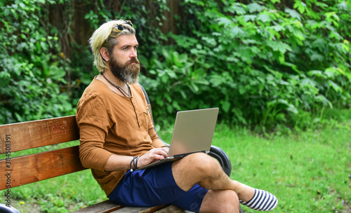 Homeschooling concept. online distant education. hipster inspired work in park. agile business. mature student working on computer. go shopping on cyber monday. bearded man sit on bench with laptop