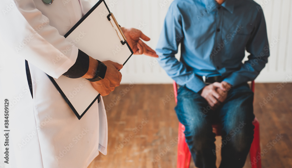 Doctors hold documents to check the health and diagnose male patients. Male health problem concept. Doctors hold documents to check the health and diagnose male patients. Male health problem concept.