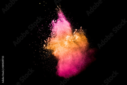 Pink orange dust particles splash on white background.Colorful powder splash.
