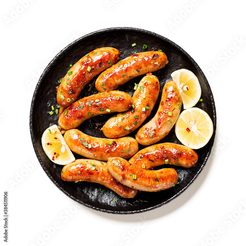 Homemade chicken sausages fried and stewed in garlic butter sauce. isolated on white background