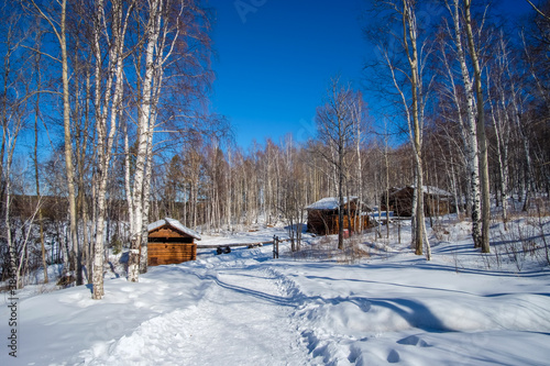 Tableau sur toile Wooden houses in Siberia during winter.