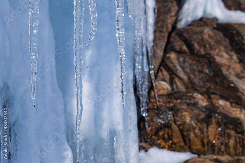 Icicles and water drops on a warm day at lake Baikal, Irkutsk, Russia. 