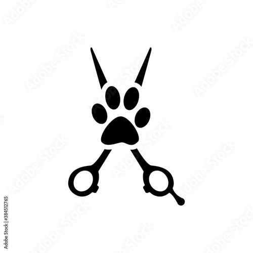 Peluquería de mascotas. Logotipo con tijera de peluquero y zarpa de perro en color negro