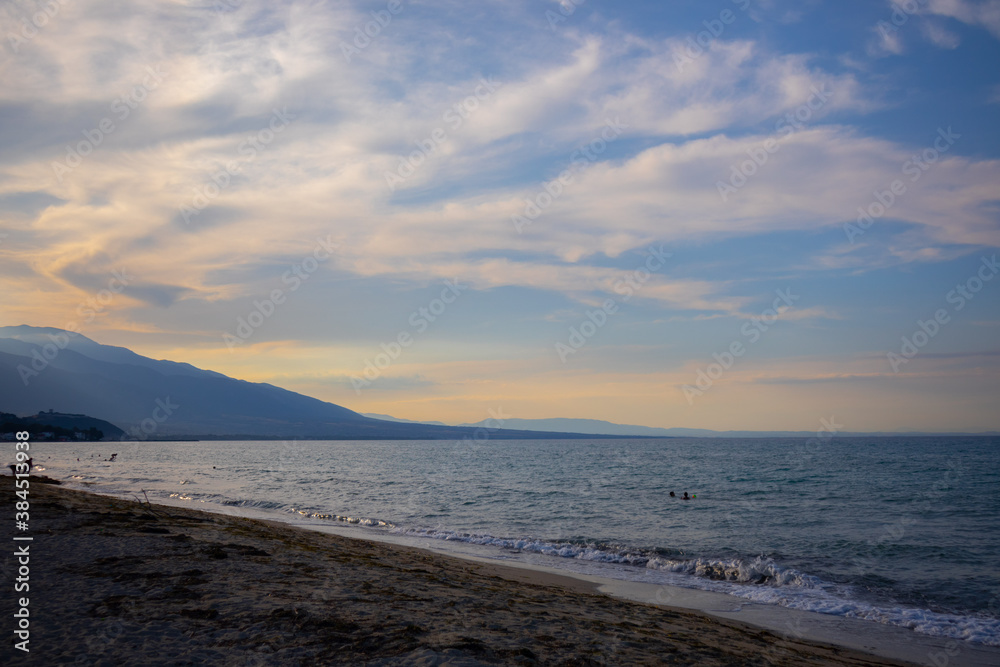 cold sunny cloudy sunset on the beach