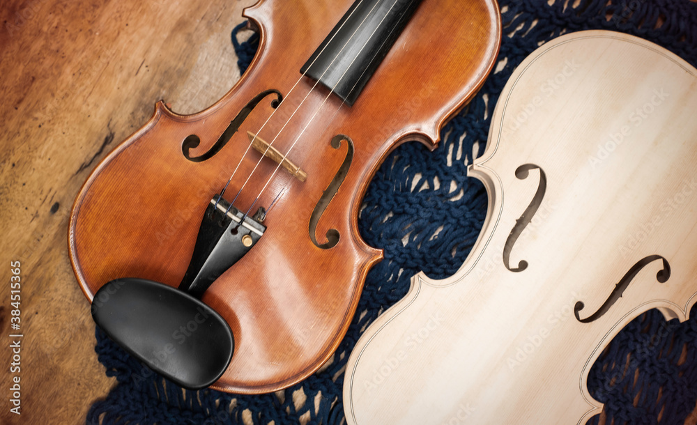 Obraz premium Front side of Raw violin and completed violin put on wooden timber board.
