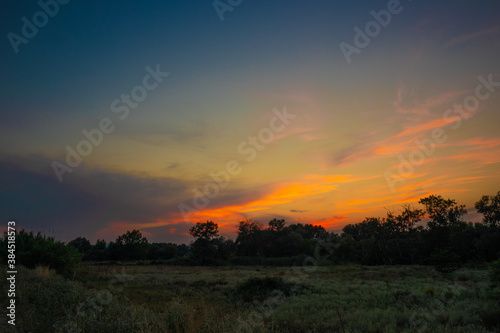 beautiful orange cloudy sunset at the fields © KyriaKos Kinatidis