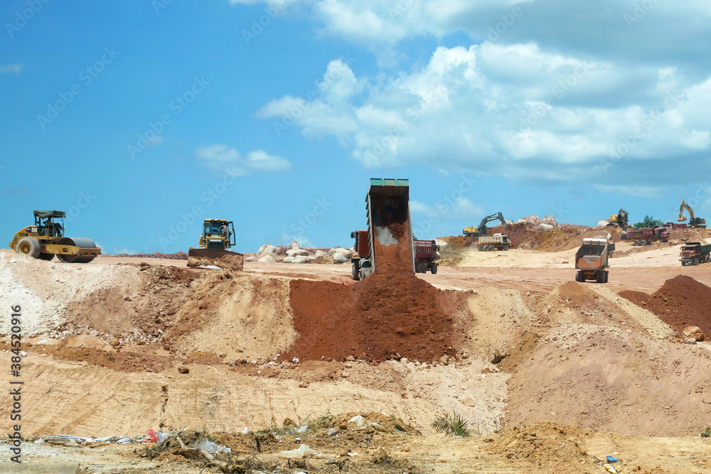 KUALA LUMPUR, MALAYSIA -JULY 17, 2019: Heavy machinery doing the soil backfilling work at the construction site. Works carried out before building construction starts to get the required levels. 
