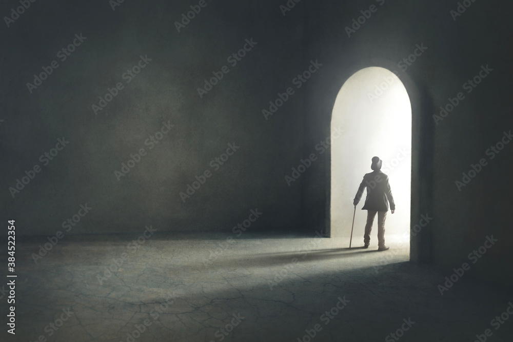 Obraz premium man entering in a mysterious light door, surreal concept