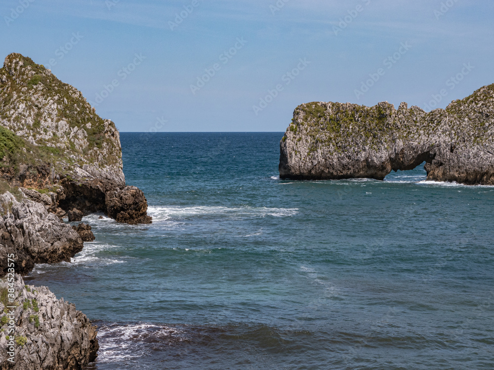 Fototapeta premium Inlet with several rocks in the middle of the sea