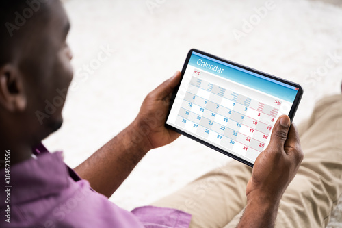 African American Male Holding Tablet