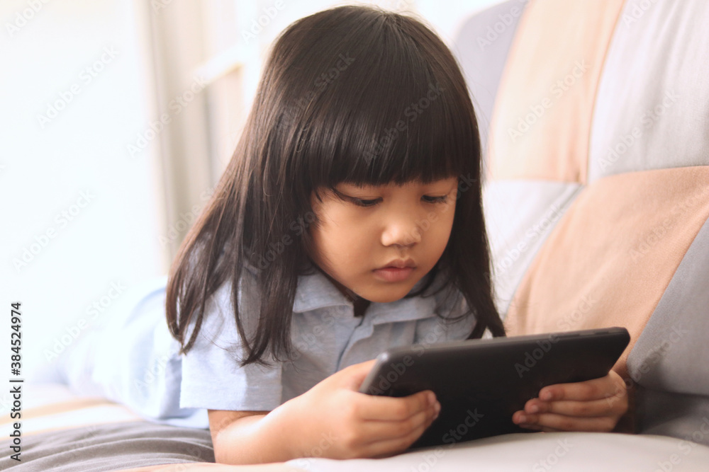 Asian little baby girl plays with gadget smart phone, children with phone addict Asian little baby girl plays with gadget smart phone, children with phone addict