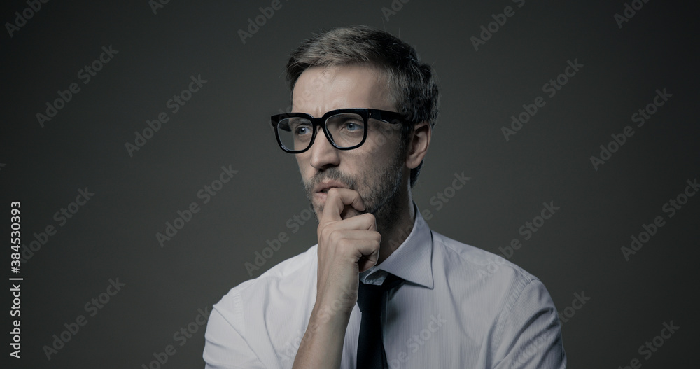 Pensive man thinking with hand on chin Pensive man thinking with hand on chin