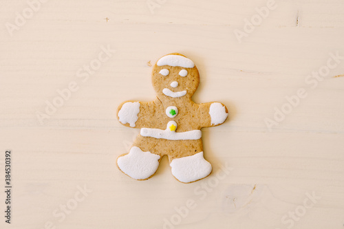 Christmas cookies gingerbread man on a wooden texture.