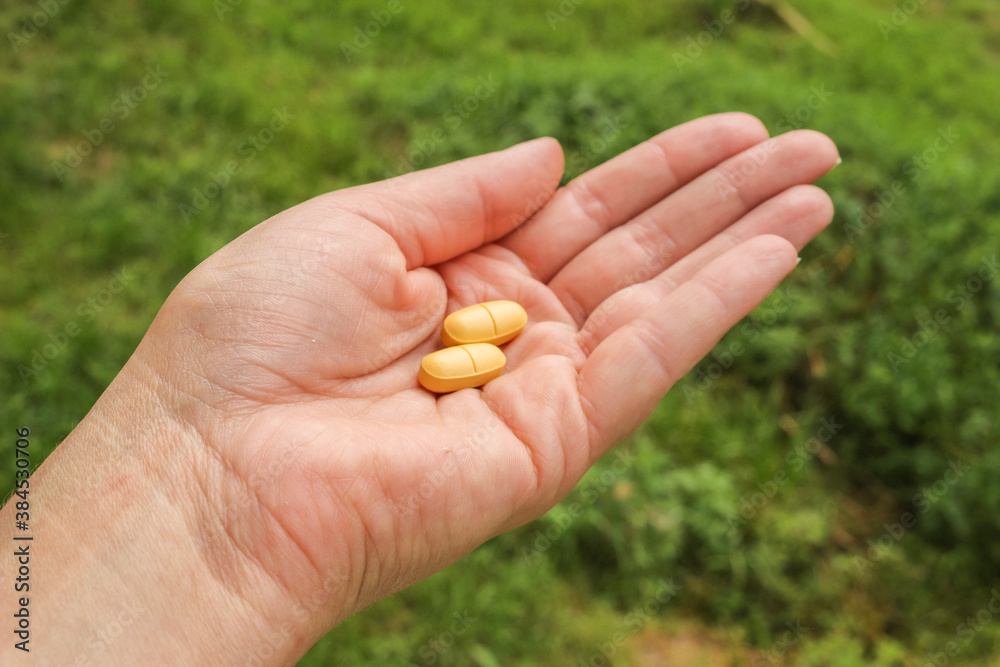 Woman with a handfull of pills, vitamins, or drugs. Woman with a handfull of pills, vitamins, or drugs.