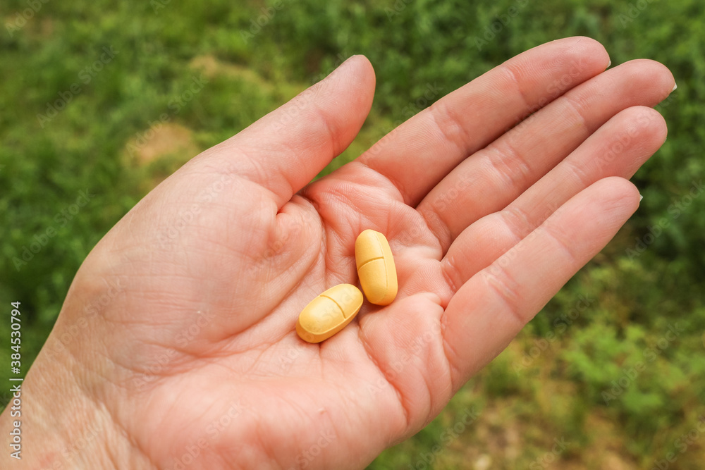 Woman with a handfull of pills, vitamins, or drugs. Woman with a handfull of pills, vitamins, or drugs.