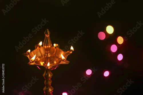 Colorful clay diya lamps lit during diwali celebration © PRASANNAPIX