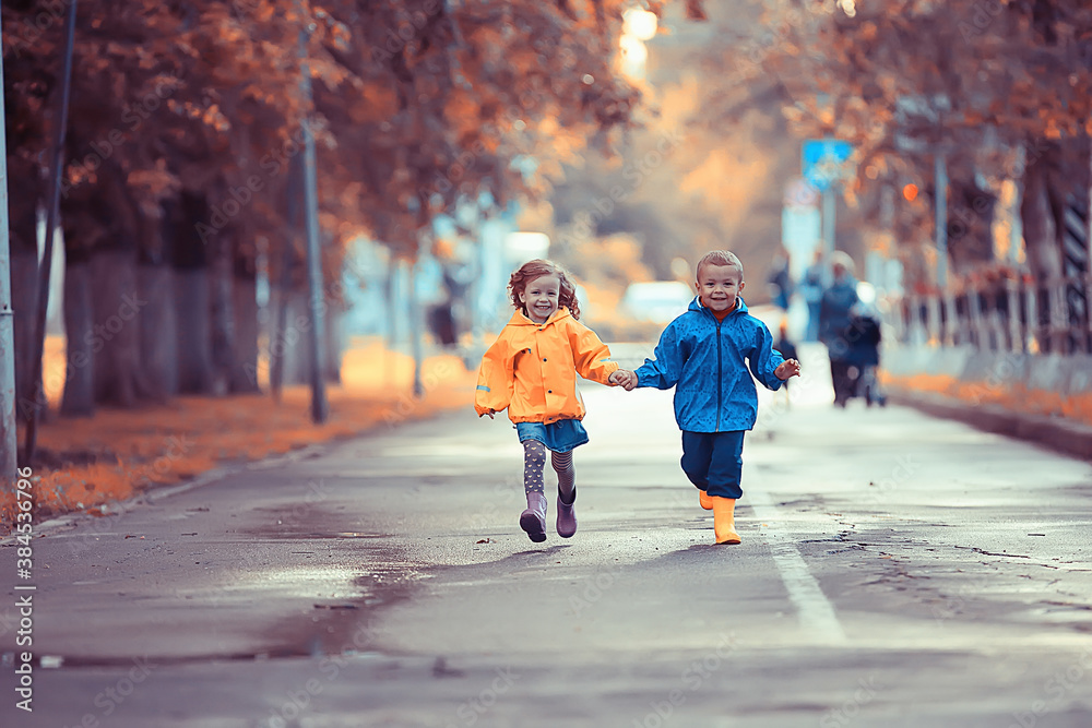 children run in the yellow autumn park rain / fun walk autumn seasonal landscape weather wet children run in the yellow autumn park rain / fun walk autumn seasonal landscape weather wet