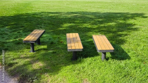 Three modern benches in a park (Gubbio, Umbria, Italy)