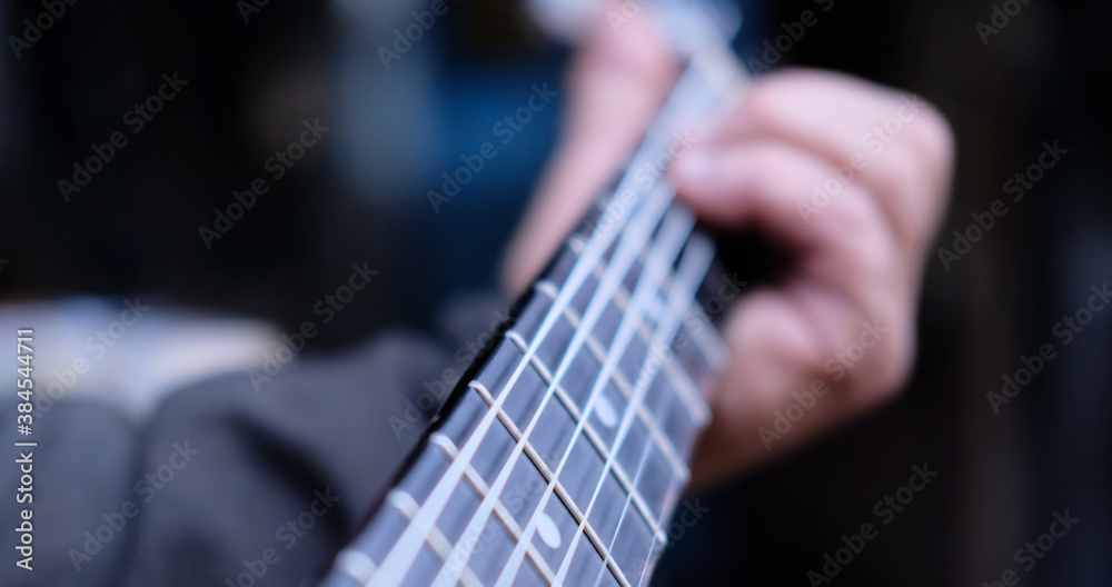 classic acoustic guitar fretboard with guitarist hand