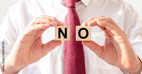 No word written on two wooden dices in hannds of businessman photo