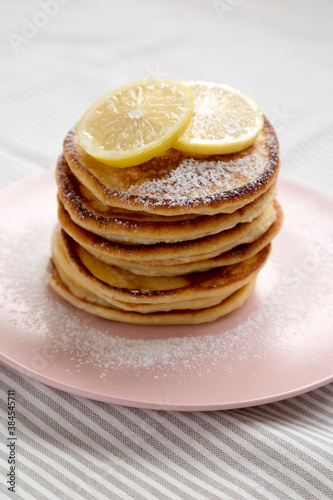Homemade Lemon Ricotta Pancakes on a pink plate, low angle view. Close-up.