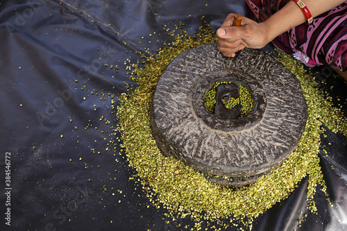 Tradition An Old Indian Hand Flour Mill. Making Moong Daal. photo