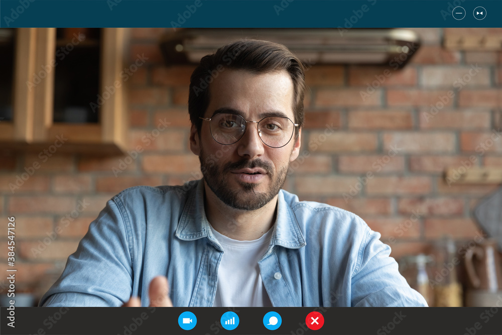 Screen application view of young Caucasian man in glasses speak talk on  video call in home office. Millennial male employee worker have webcam  digital conference with colleagues or online briefing. foto de