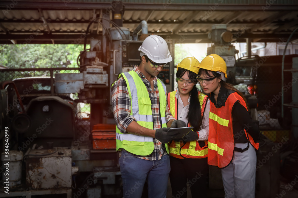 Leader supervisor training with new engineer and technician while working or operate in factory, team adjust and control at maintenance machine shop 