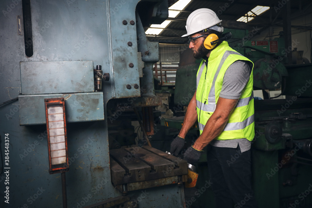 A engineer or technician or worker working with blue print drawing spec about machine part preparing or operate or repair maintenance in factory A engineer or technician or worker working with blue print drawing spec about machine part preparing or operate or repair maintenance in factory
