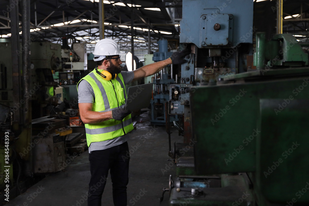 A engineer or technician or worker working with blue print drawing spec about machine part preparing or operate or repair maintenance in factory A engineer or technician or worker working with blue print drawing spec about machine part preparing or operate or repair maintenance in factory