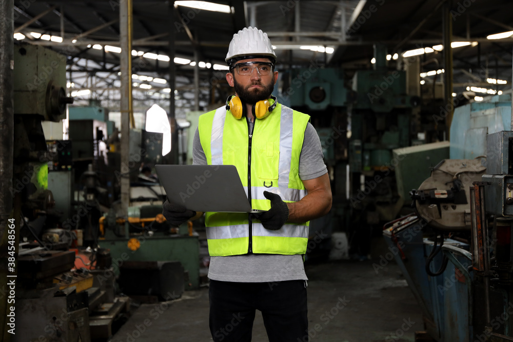 A engineer or technician or worker working with blue print drawing spec about machine part preparing or operate or repair maintenance in factory A engineer or technician or worker working with blue print drawing spec about machine part preparing or operate or repair maintenance in factory