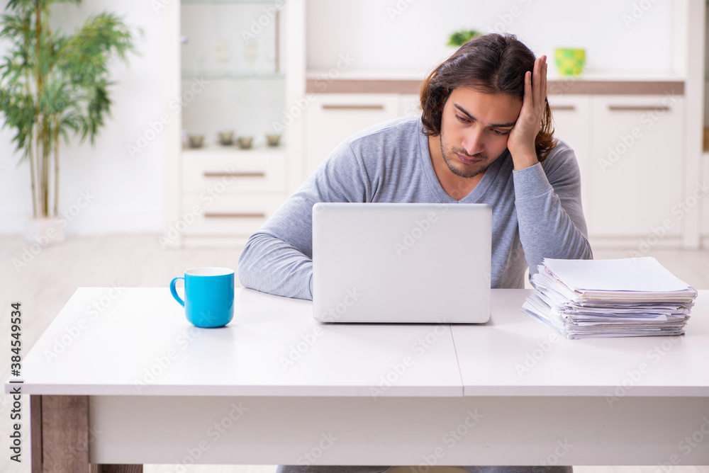 Young male employee freelancer working from home Young male employee freelancer working from home
