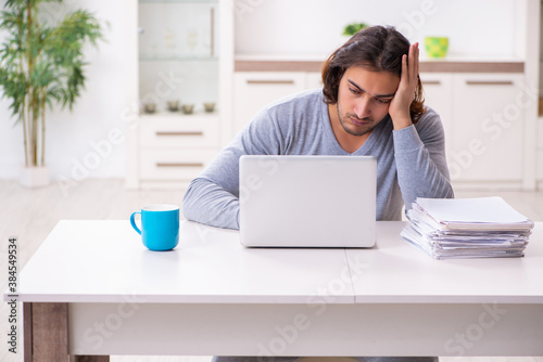 Young male employee freelancer working from home