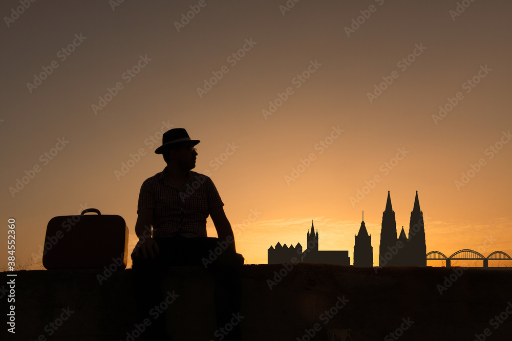 man in front of cologne city skyline