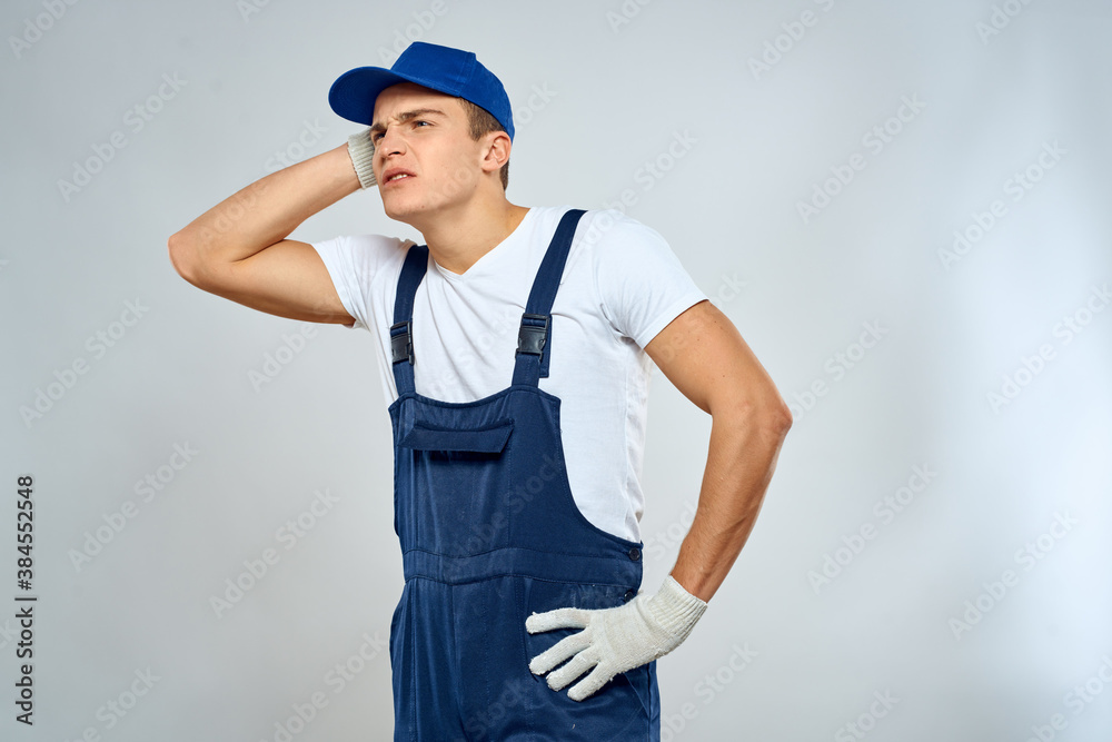 Man worker in forklift uniform delivery service light background Man worker in forklift uniform delivery service light background