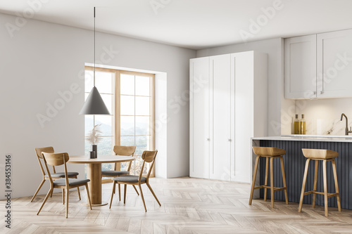 Modern white and gray kitchen corner with dining table and bar