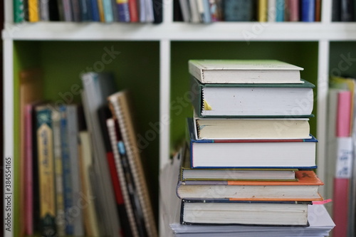 soft focus of the books stacked up on bookshelf background. © apisit