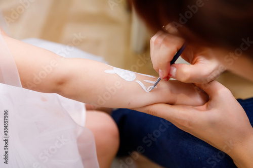 woman draws on a child s hand