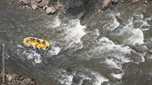Topview of people in a boat. Seething flows of river water.