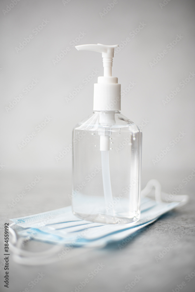 antiseptic hand gel in a transparent plastic bottle and mask antiseptic hand gel in a transparent plastic bottle and mask