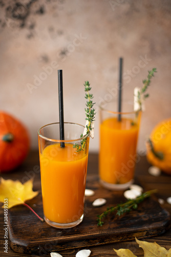 freshly squeezed pumpkin juice with thyme in tall glasses