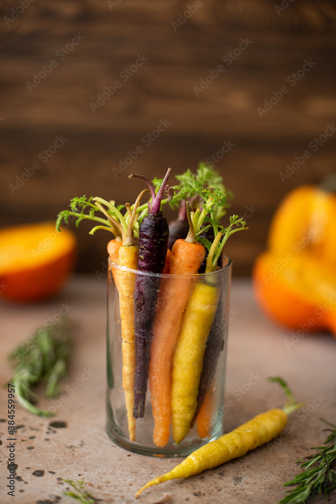 small multi-colored carrot in a glass