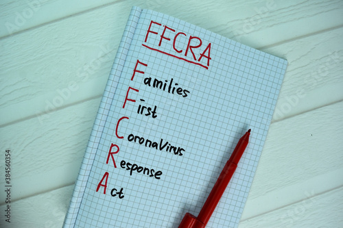 FFCRA - Families First Coronavirus Response Act write on a book isolated on office desk. photo