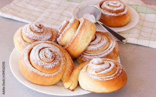 Soft, fluffy buns sprinkled with powdered sugar