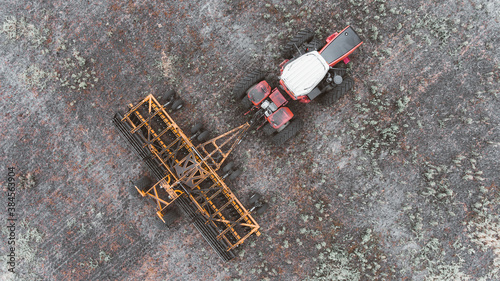 tractor in the field with a disc harrow
