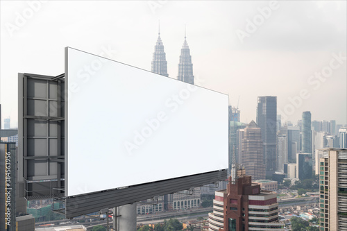 Blank white road billboard with KL cityscape background at day time. Street advertising poster  mock up  3D rendering. Side view. The concept of marketing communication to promote or sell idea.