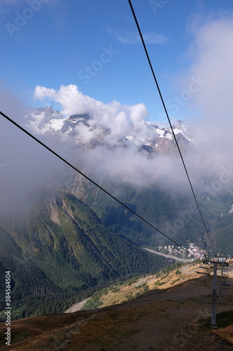 hill view. grassy mountainside. rise in height. ropeway. cable car.