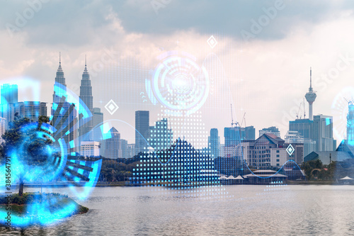 Photography Hologram of abstract technology glowing icons, panoramic cityscape of Kuala Lumpur at sunset, Malaysia, Asia