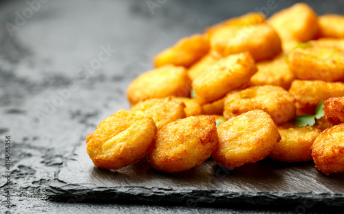 Mini hash browns, tater tots crispy golden potato bites served with jalapeno peppers dipped in ketchup